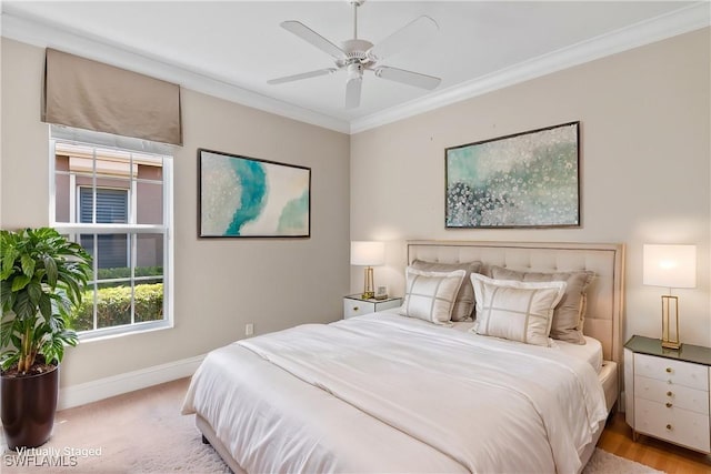 bedroom featuring baseboards, ornamental molding, and a ceiling fan