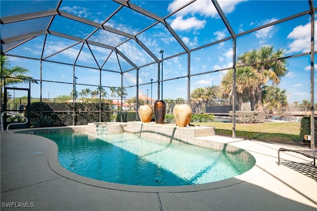 view of pool with a pool with connected hot tub, a patio, and a lanai