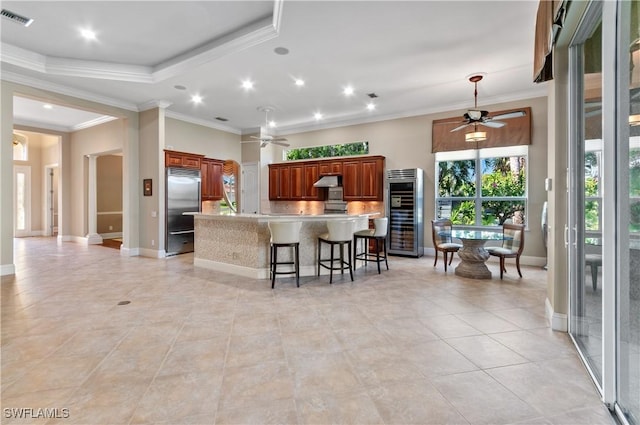 kitchen featuring light countertops, visible vents, ceiling fan, and built in fridge
