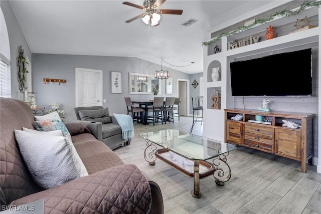 living area with plenty of natural light, light wood-style floors, visible vents, lofted ceiling, and ceiling fan with notable chandelier