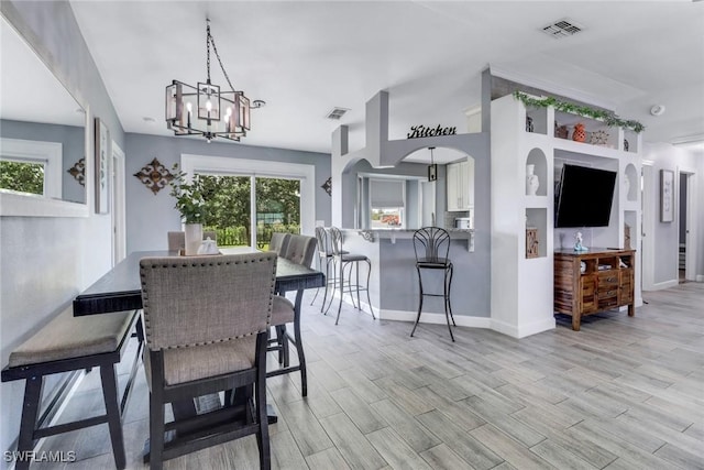 dining area featuring an inviting chandelier, baseboards, and visible vents