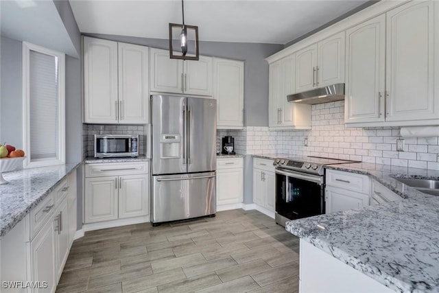 kitchen featuring white cabinetry, light stone countertops, appliances with stainless steel finishes, and under cabinet range hood
