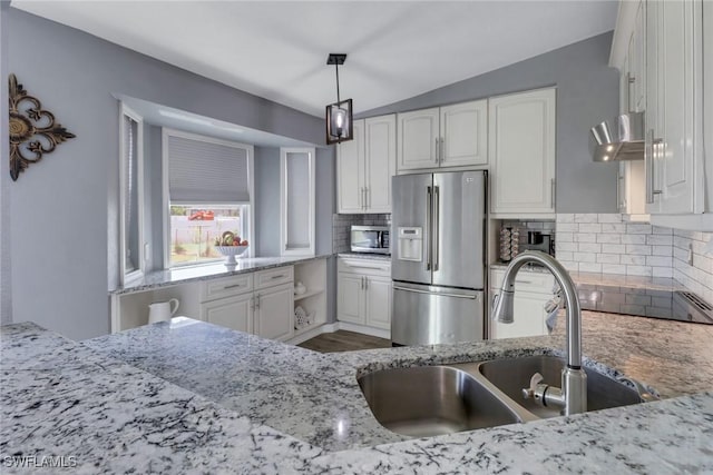 kitchen featuring a sink, white cabinets, decorative backsplash, and stainless steel appliances