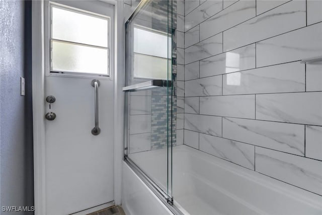 full bath featuring shower / bath combination with glass door