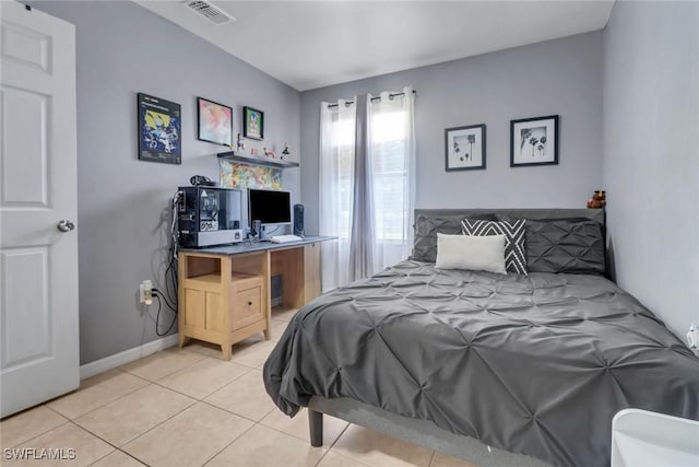 bedroom featuring light tile patterned floors, baseboards, and visible vents
