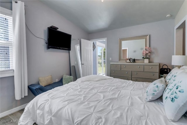 bedroom featuring baseboards and wood finished floors