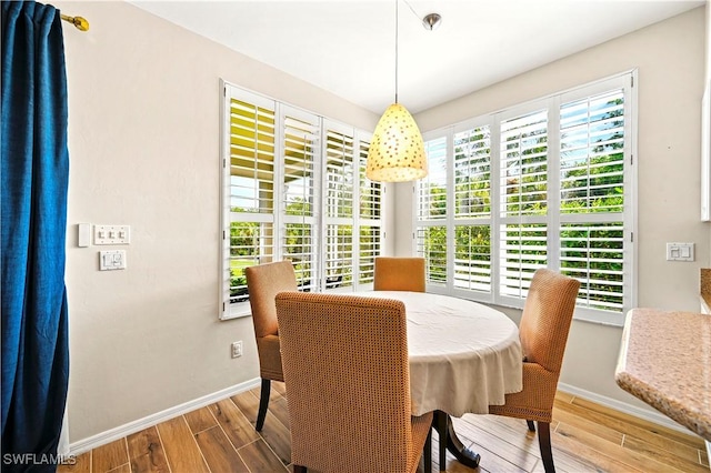 dining area with wood finished floors and baseboards