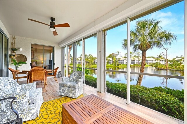 sunroom / solarium with a water view and wood finished floors