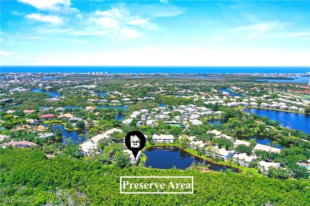 aerial view of property's location featuring a nearby body of water and nearby suburban area