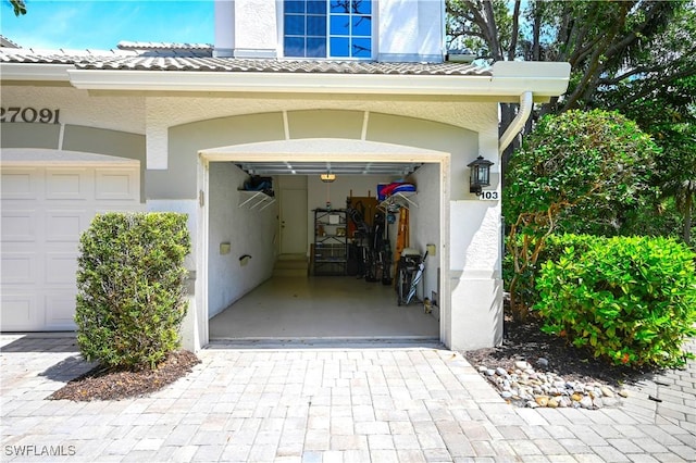 garage featuring decorative driveway