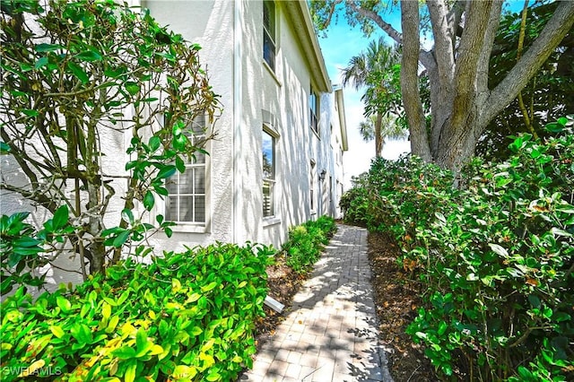 view of side of home with stucco siding