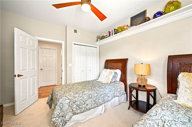 bedroom featuring carpet, a closet, ceiling fan, and baseboards