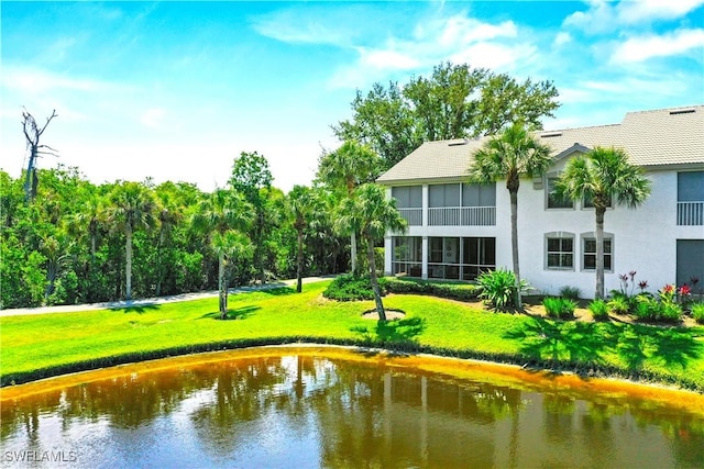 view of home's community with a yard and a water view