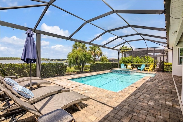 13504 Blue Bay Cir, Miromar Lakes, FL 33913 - view of swimming pool with a patio, a pool with connected hot tub, and glass enclosure