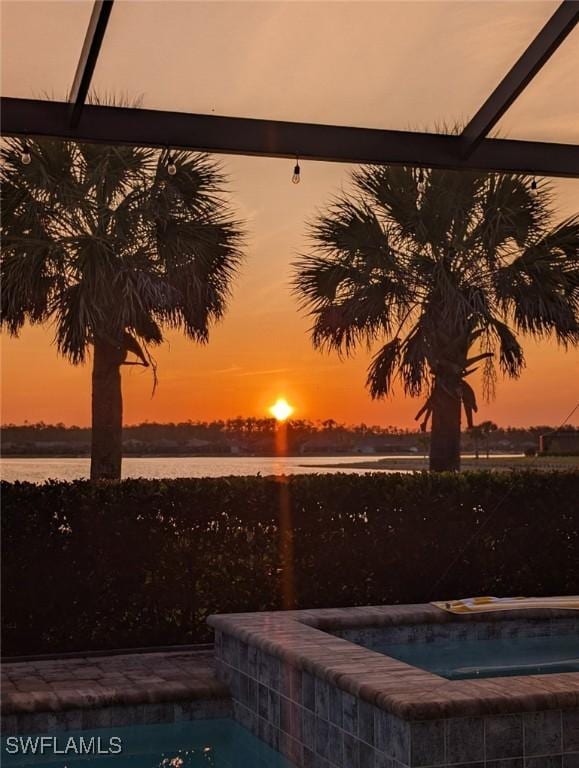13504 Blue Bay Cir, Miromar Lakes, FL 33913 - pool at dusk with a water view, an in ground hot tub, and glass enclosure