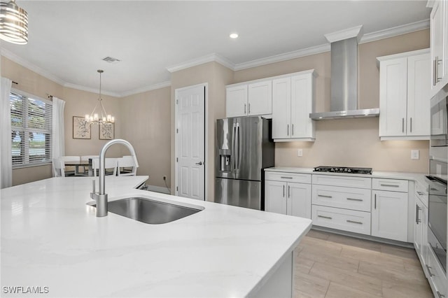 13504 Blue Bay Cir, Miromar Lakes, FL 33913 - kitchen with wall chimney exhaust hood, visible vents, a chandelier, a sink, and stainless steel fridge
