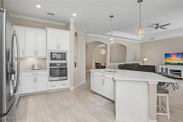 13504 Blue Bay Cir, Miromar Lakes, FL 33913 - kitchen featuring visible vents, arched walkways, a sink, open floor plan, and stainless steel appliances