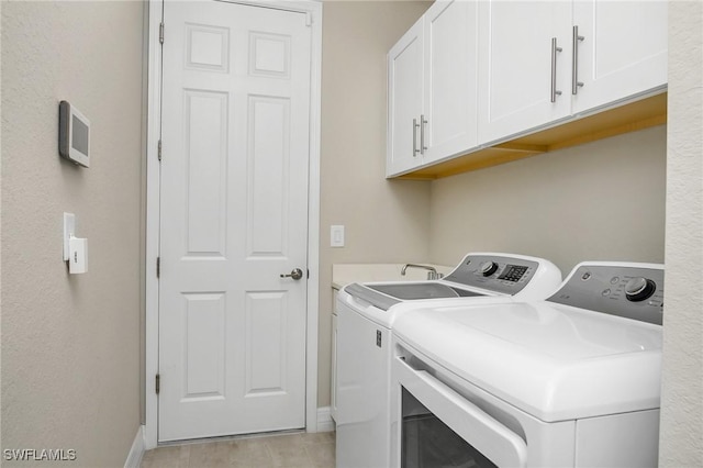 13504 Blue Bay Cir, Miromar Lakes, FL 33913 - washroom featuring washer and clothes dryer, baseboards, and cabinet space