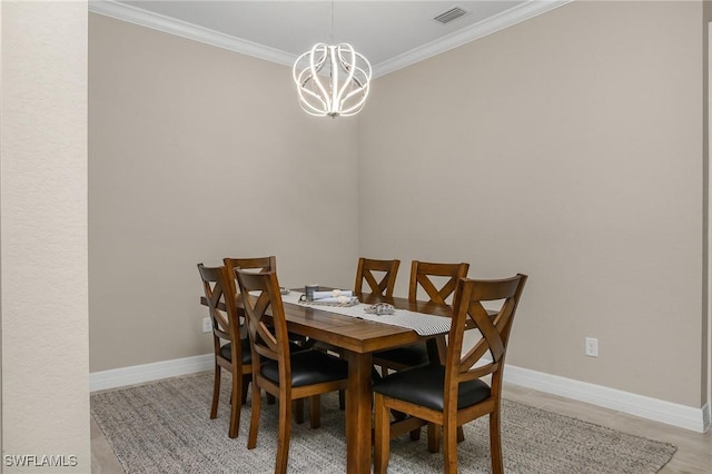 13504 Blue Bay Cir, Miromar Lakes, FL 33913 - dining area featuring a chandelier, visible vents, baseboards, and crown molding