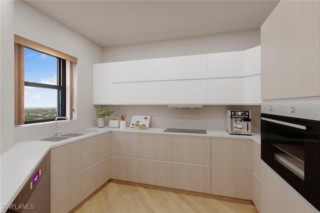 kitchen featuring light countertops, oven, and modern cabinets