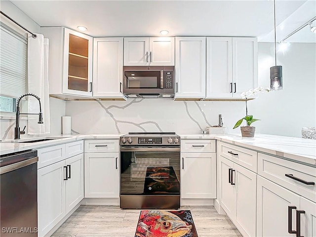 1320 Blue Point Ave Unit 2, Naples, FL 34102 - kitchen with stainless steel appliances, a sink, white cabinetry, and recessed lighting