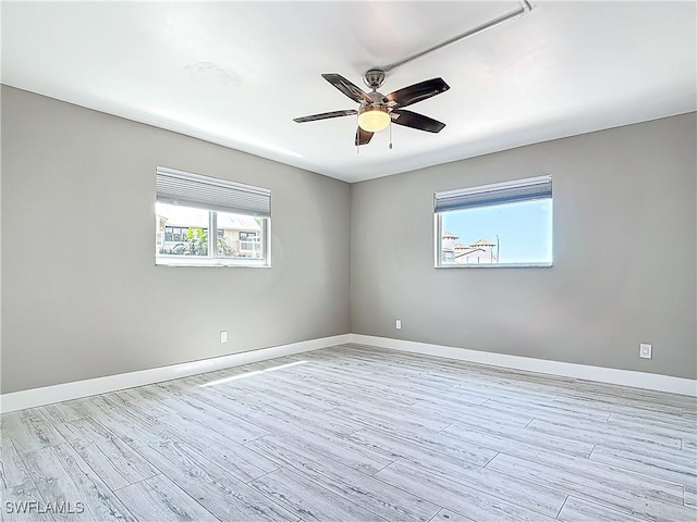 1320 Blue Point Ave Unit 2, Naples, FL 34102 - empty room with ceiling fan, light wood-style flooring, and baseboards