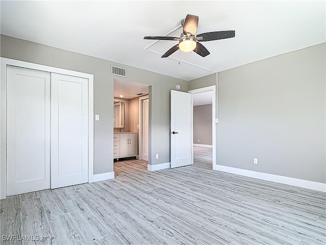 1320 Blue Point Ave Unit 2, Naples, FL 34102 - unfurnished bedroom featuring baseboards, light wood-type flooring, a closet, connected bathroom, and ceiling fan