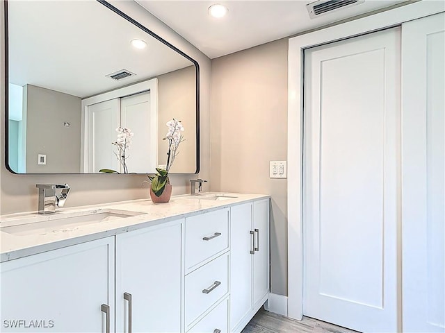 1320 Blue Point Ave Unit 2, Naples, FL 34102 - bathroom featuring recessed lighting, double vanity, and wood finished floors