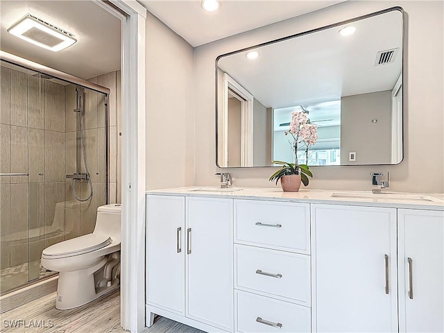 1320 Blue Point Ave Unit 2, Naples, FL 34102 - bathroom featuring toilet, a stall shower, double vanity, wood finished floors, and recessed lighting