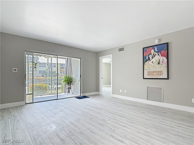 1320 Blue Point Ave Unit 2, Naples, FL 34102 - empty room featuring light wood-style flooring, baseboards, and a smoke detector
