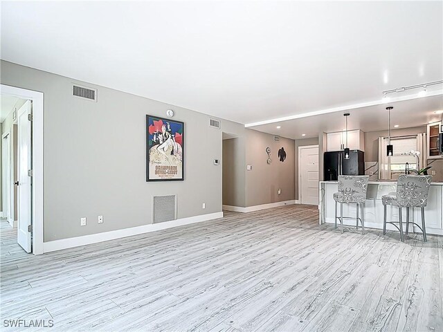 1320 Blue Point Ave Unit 2, Naples, FL 34102 - unfurnished living room featuring light wood-style flooring and baseboards