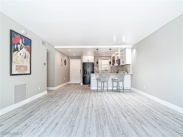 1320 Blue Point Ave Unit 2, Naples, FL 34102 - unfurnished living room with light wood finished floors and baseboards