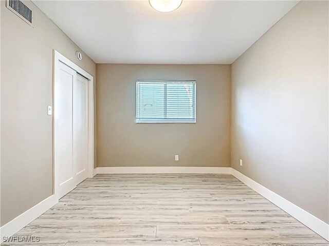 1320 Blue Point Ave Unit 2, Naples, FL 34102 - unfurnished bedroom featuring light wood-style flooring, a closet, and baseboards