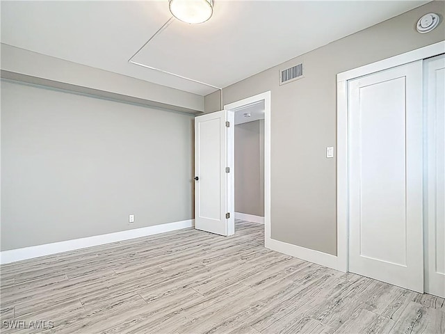 1320 Blue Point Ave Unit 2, Naples, FL 34102 - unfurnished bedroom featuring light wood-style floors, baseboards, and a closet