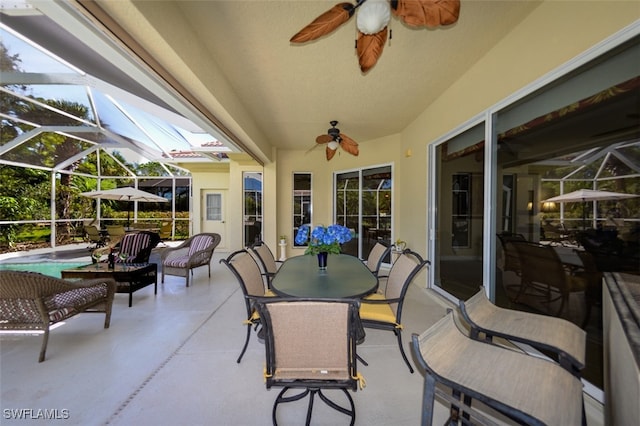 view of patio featuring outdoor dining area, an outdoor pool, a lanai, and ceiling fan