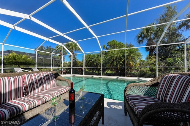 outdoor pool with a patio area, outdoor lounge area, and glass enclosure