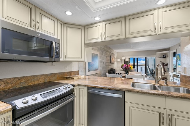 4835 Bonita Beach Rd Unit 407, Bonita Springs, FL 34135 - kitchen featuring stainless steel appliances, a sink, and cream cabinetry