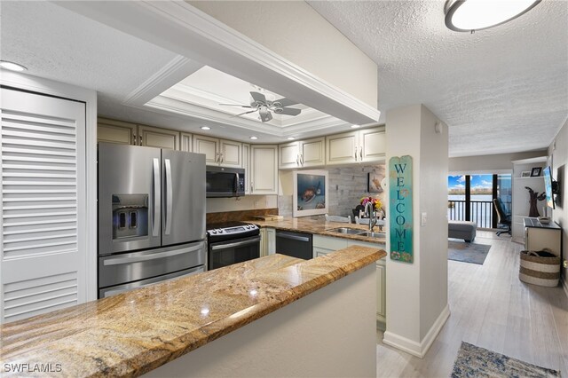 4835 Bonita Beach Rd Unit 407, Bonita Springs, FL 34135 - kitchen with a sink, light stone countertops, a textured ceiling, and stainless steel appliances