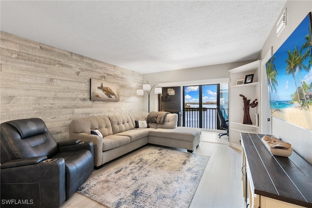4835 Bonita Beach Rd Unit 407, Bonita Springs, FL 34135 - living room with wooden walls, wood finished floors, and a textured ceiling