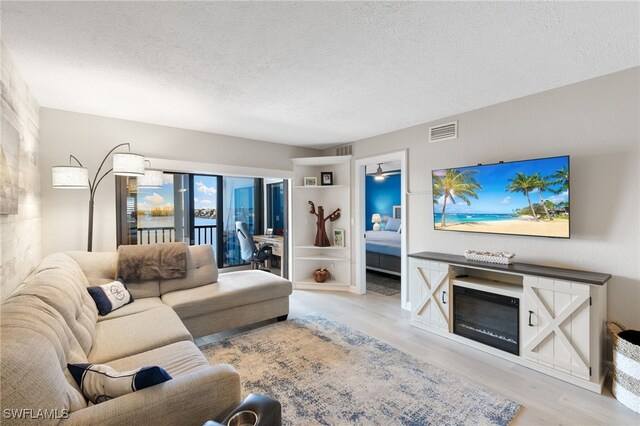 4835 Bonita Beach Rd Unit 407, Bonita Springs, FL 34135 - living area with visible vents, wood finished floors, and a textured ceiling