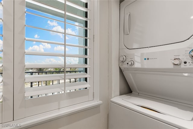 4835 Bonita Beach Rd Unit 407, Bonita Springs, FL 34135 - laundry room featuring a wealth of natural light, stacked washing maching and dryer, and laundry area