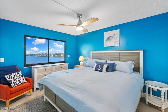 4835 Bonita Beach Rd Unit 407, Bonita Springs, FL 34135 - bedroom with ceiling fan, wood finished floors, and a textured ceiling