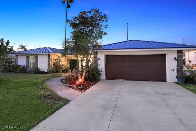 2135 SE 15th St, Cape Coral, FL 33990 - ranch-style home featuring stucco siding, a standing seam roof, a garage, a front yard, and a metal roof