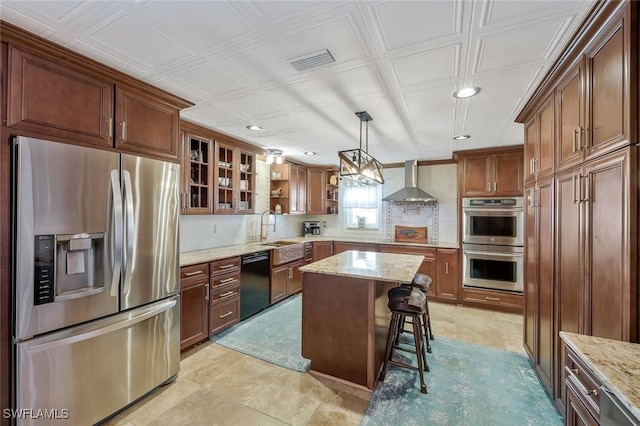 2135 SE 15th St, Cape Coral, FL 33990 - kitchen with appliances with stainless steel finishes, wall chimney exhaust hood, recessed lighting, light stone counters, and open shelves