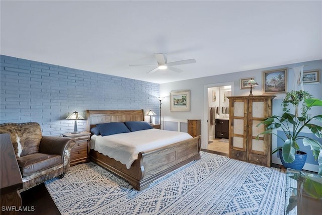 2135 SE 15th St, Cape Coral, FL 33990 - bedroom featuring brick wall, ensuite bath, and a ceiling fan