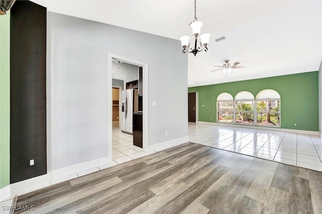 27375 Imperial Oaks Cir, Bonita Springs, FL 34135 - spare room featuring ceiling fan with notable chandelier, baseboards, tile patterned flooring, and visible vents