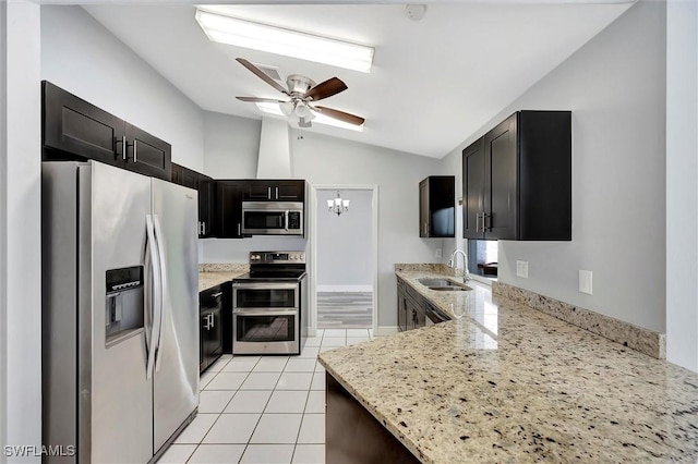27375 Imperial Oaks Cir, Bonita Springs, FL 34135 - kitchen featuring ceiling fan with notable chandelier, light stone countertops, appliances with stainless steel finishes, a sink, and lofted ceiling