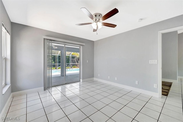 27375 Imperial Oaks Cir, Bonita Springs, FL 34135 - empty room featuring light tile patterned floors, ceiling fan, and baseboards