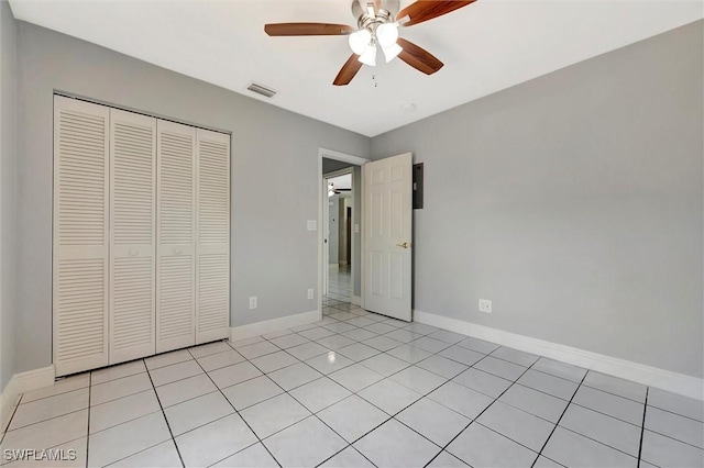 27375 Imperial Oaks Cir, Bonita Springs, FL 34135 - unfurnished bedroom with ceiling fan, light tile patterned floors, a closet, visible vents, and baseboards