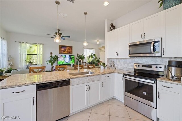 5448 Agostino Way, Ave Maria, FL 34142 - kitchen featuring a peninsula, open floor plan, plenty of natural light, a sink, and stainless steel appliances